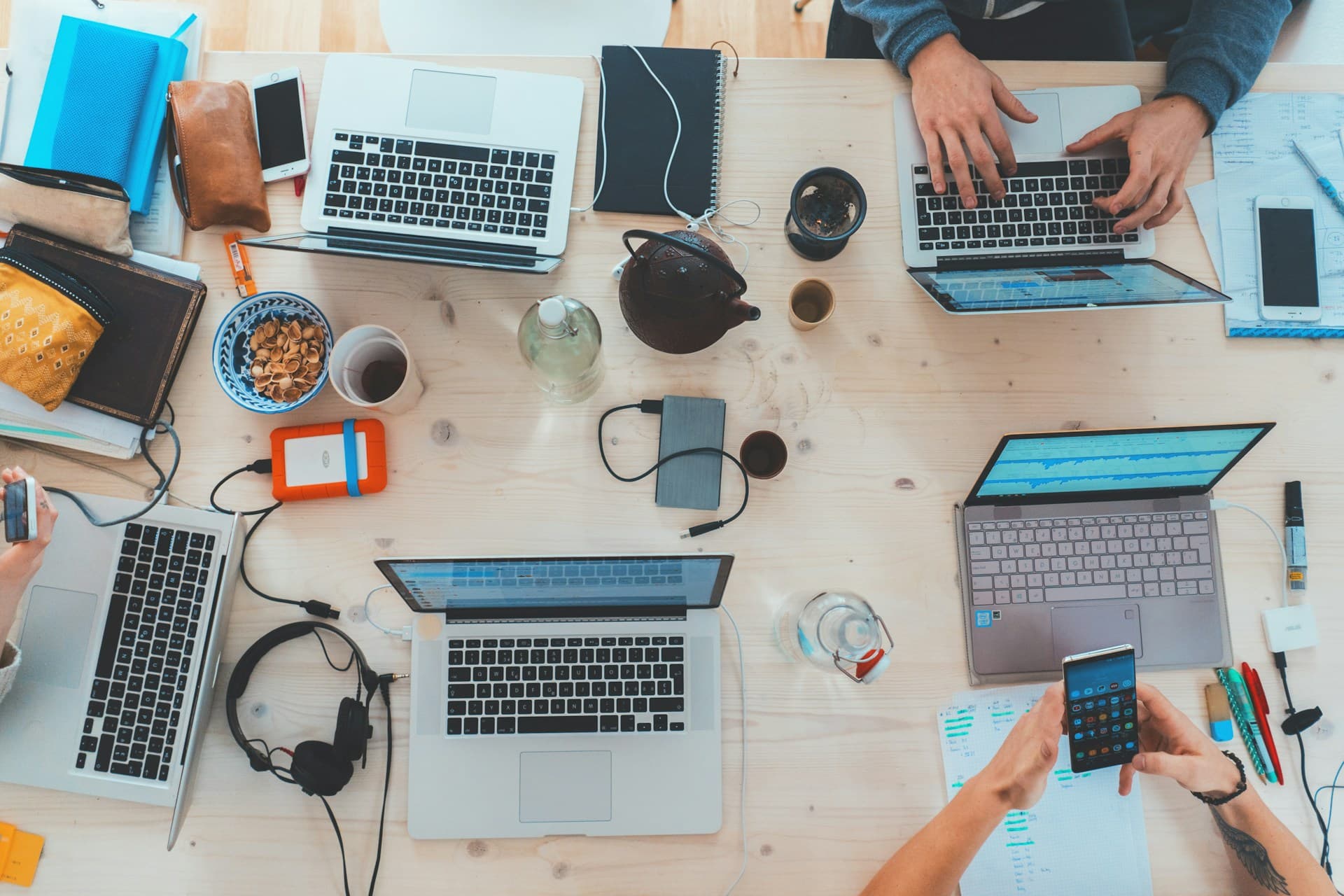 Digital agency workspace with multiple laptops and growth planning